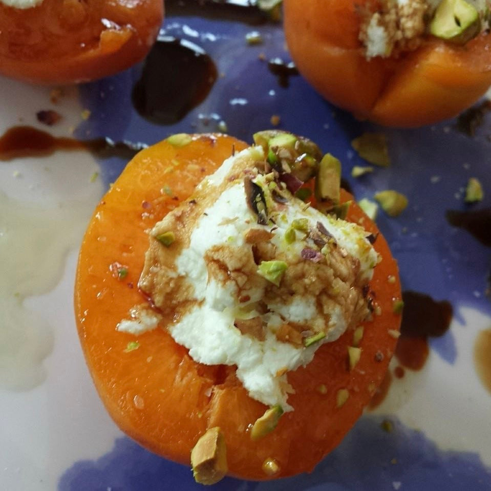 Fresh, halved apricots stuffed with goat cheese, topped with chopped pistachios and drizzled with balsamic vinegar.