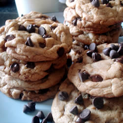 Stacks of chocolate chip cookies served on a blue plate.