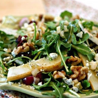 Arugula salad with dried cranberries, apple slices, walnuts, and blue cheese crumbles.