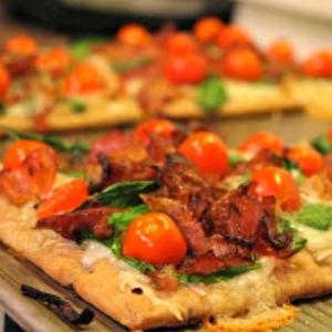 Flatbreads topped with brie cheese, basil, tomatoes, and crispy prosciutto.