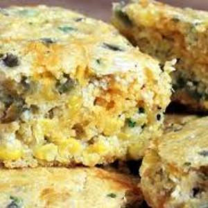 Slices of cornbread with corn, jalapenos, cheese, and bell pepper inside.