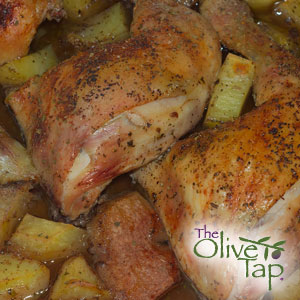 A close-up of seasoned chicken breasts on a bed of seasoned potatoes.