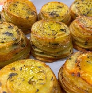 A plate of crispy, spiraled rosemary potatoes.
