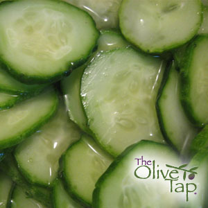A close-up of sliced cucumbers drizzled with a light balsamic vinegar.