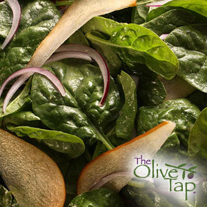 A bed of spinach with sliced red onions and pears.