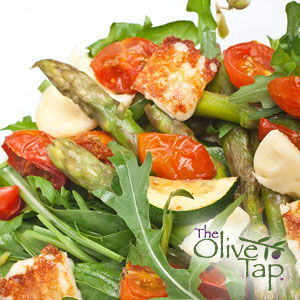 Arugula topped with asparagus, mozzarella cheese, and tomatoes.