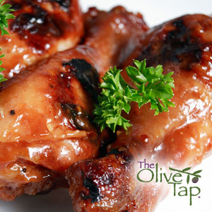 Glazed chicken drumsticks garnished with fresh parsley.