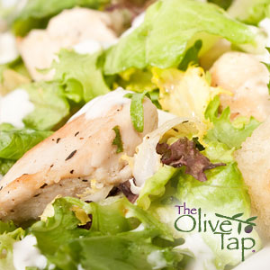 Mixed greens salad with feta cheese and pieces of herb chicken.