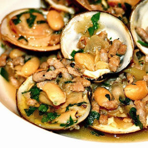 Clams served in their shells with white beans, herbs, sausage, and bacon in a savory broth.