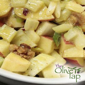 Waldorf salad made with crisp diced apples, celery, walnuts, and raisins, lightly coated in a creamy dressing and served in a white bowl.