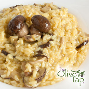 Creamy mushroom risotto made with whole button mushrooms and sliced mushrooms, cooked to a rich, velvety consistency and served on a white plate.