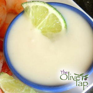 Creamy yogurt lime dressing garnished with a lime slice and served in a blue bowl.