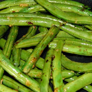 Blistered green beans that are seasoned and tossed in a serrano pepper honey vinegar.