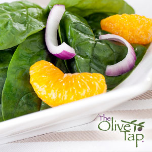 Spinach salad with mandarin oranges and red onion slices.