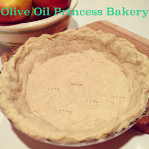 A pie crust pressed into a pie dish and resting on a wooden cutting board.