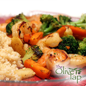 Sauteed shrimp and vegetables, including broccoli and carrots, served with brown rice.