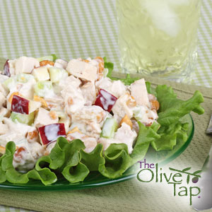 Lettuce leaves topped with chicken salad with apples, pears, and onions, tossed in a creamy sauce.
