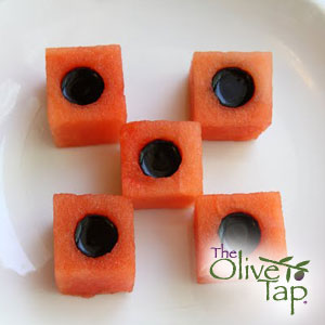 Watermelon cubes with black filling, served on a white plate.