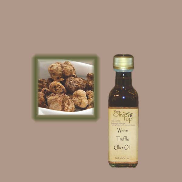 A bottle of White Truffle Olive Oil with a inset image of truffles on a beige background.