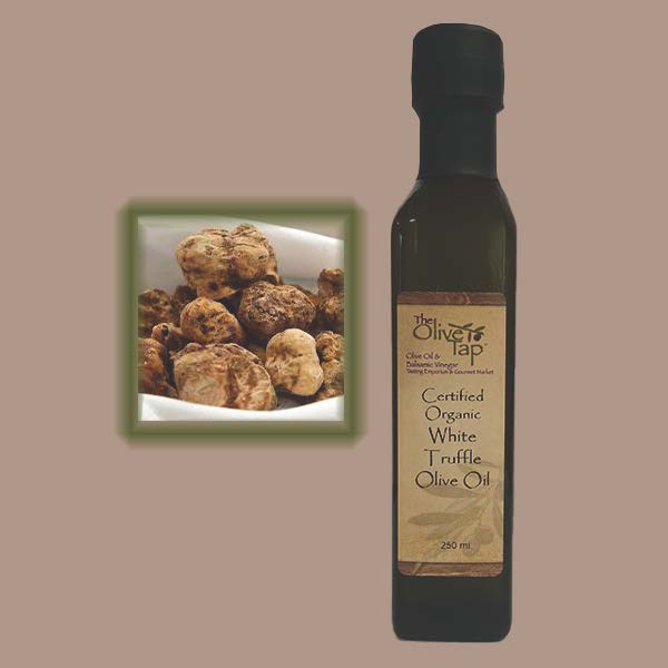 A bottle of Certified Organic White Truffle Oil from The Olive Tap with an inset showing fresh truffles on a light background.