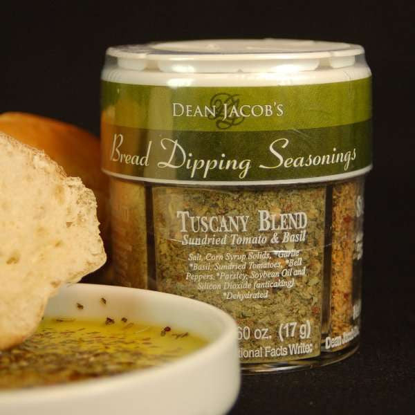 4 Variety Bread Dipping Seasonings Regular Size from The Olive Tap next to a bread dipping dish with olive oil inside  and fresh pieces of bread.