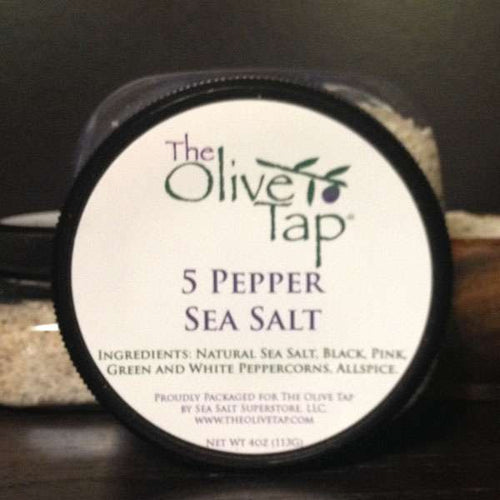 5 Pepper Sea Salt from The Olive Tap: A jar with a white label that includes The Olive Tap logo with an olive branch, product name, and ingredients list, with the jar in front of a gray background.