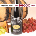 Bottle of Aceto Balsamico di Modena, 3 Leaf Quality from The Olive Tap surrounded by grapes in front of a wooden barrel, and a sweetness scale indicating a two.