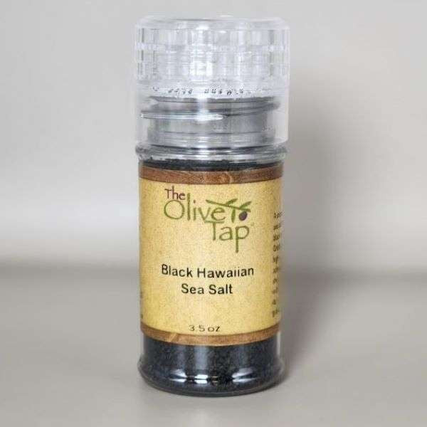 Black Hawaiian Sea Salt in a grinder jar from The Olive Tap with The Olive Tap logo and olive branch against a neutral background.