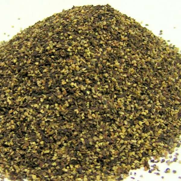 Gourmet Grind Black Pepper from The Olive Tap: a pile of green, brown, and black spices on a light background.