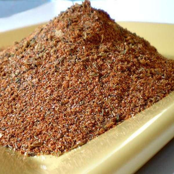 Cajun Blackening Seasoning from The Olive Tap: A pile of red, brown, and green spices in a gold dish.