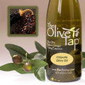 A bottle of Chipotle Olive Oil from The Olive Tap with olives and leaves with an inset showing a whole chipotle pepper next to a pile of crushed pepper.