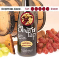 A bottle of Cranberry Walnut Riserva Balsamic Vinegar from The Olive Tap with a picture of cranberries and walnuts, surrounded by grapes in front of a wooden barrel, and a sweetness scale indicating a five on a light background.