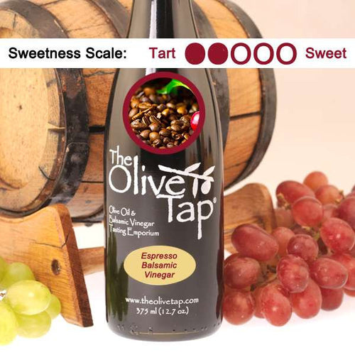 A bottle of Espresso Balsamic Vinegar from The Olive Tap with a picture of espresso beans, in front of a wooden barrel, and a sweetness scale indicating a two.