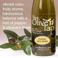 A bottle of Frantoio 100% Extra Virgin Olive Oil from The Olive Tap with olives and leaves including text describing the olive oil flavor profile on a light background.