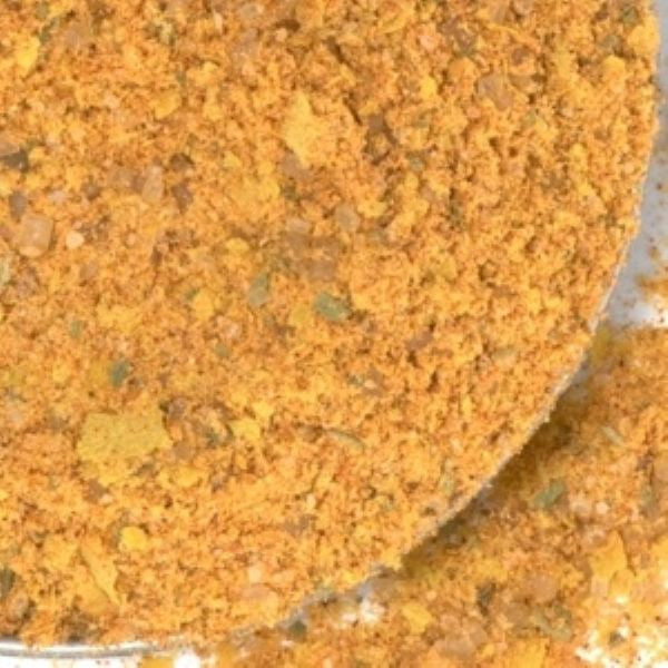 Mexican Street Corn Seasoning from The Olive Tap: A bowl of yellow, orange, and green spices mixed together.