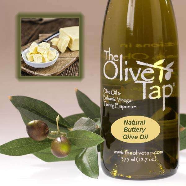 A bottle of Natural Buttery Olive Oil from The Olive Tap next to olives and leaves with an inset showing fresh chunks of butter in a bowl next to a stick of butter.