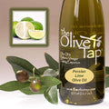 A bottle of Persian Lime Olive Oil from The Olive Tap next to olives and leaves with an inset showing fresh limes.