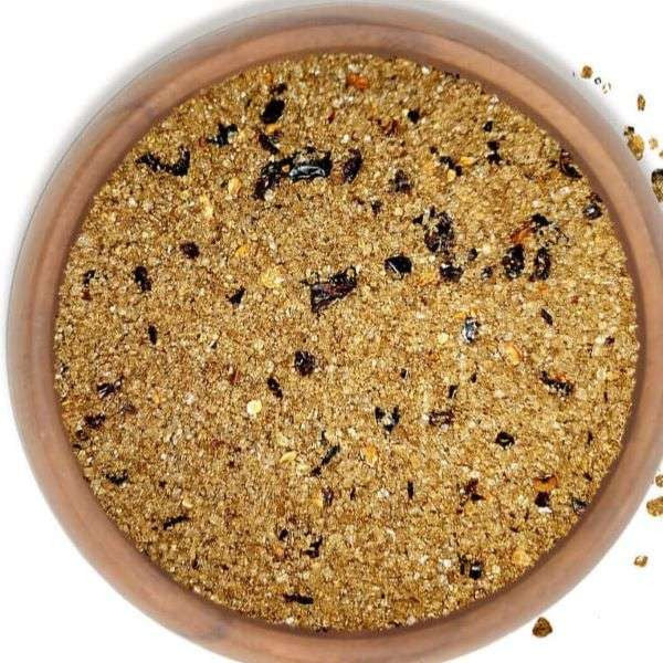 Spicy Smoked Bacon Sea Salt from The Olive Tap: tan grains of salt and bacon mixture with chipotle pepper pieces.