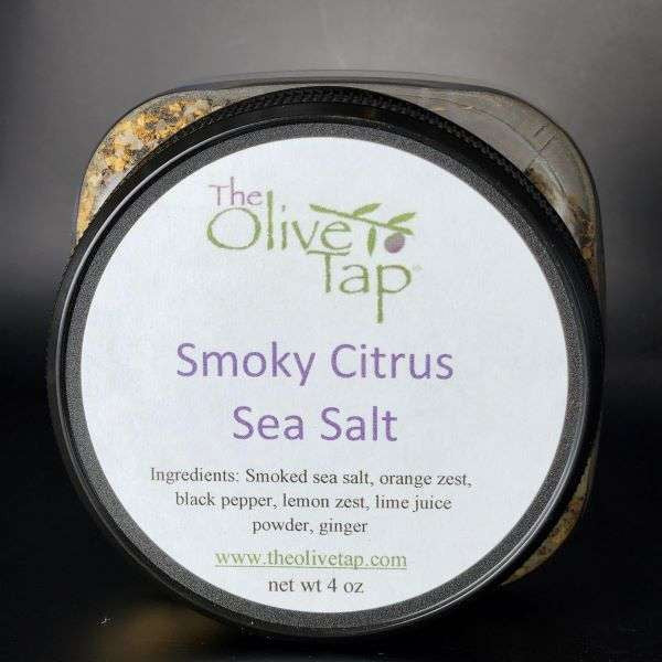 Smoky Citrus Sea Salt in jar from The Olive Tap with a white label, The Olive Tap logo, and ingredients list with a gray background behind the jar.