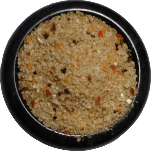 Spicy Garlic Pepper Sea Salt from The Olive Tap:  Tan-colored pebble-sized chunks of sea salt with orange and brown flakes in a black bowl and a white background.