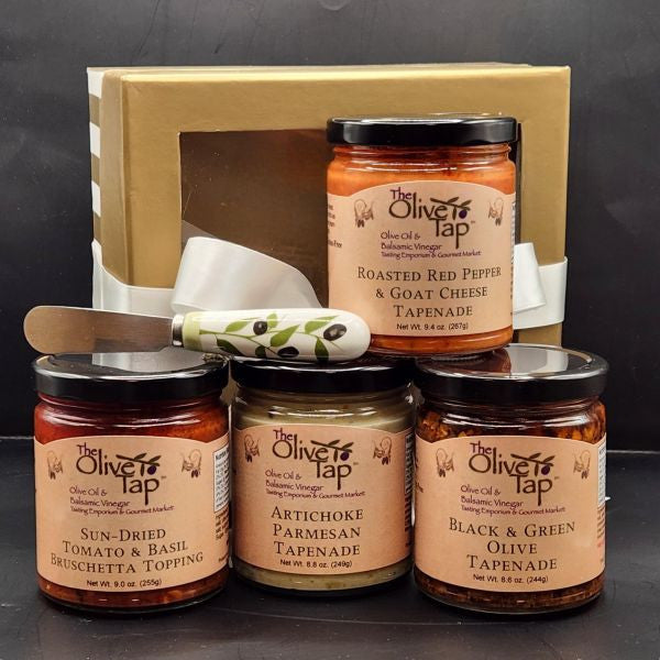 Collection of tapenade jars from The Olive Tap with a spreader and gold gift box.
