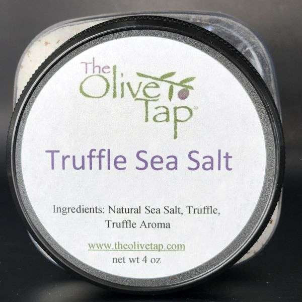 A jar of Truffle Sea Salt from The Olive Tap  with a white label that includes The Olive Tap logo with an olive branch, product name, and ingredients list, with the jar in front of a gray background.
