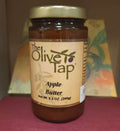 A jar of Apple Butter from The Olive Tap with a colorful background.