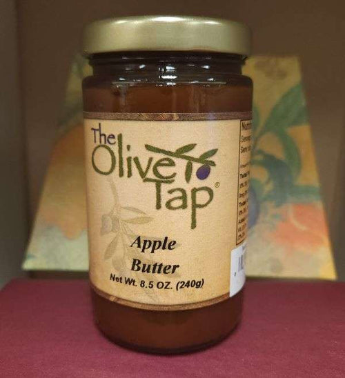 A jar of Apple Butter from The Olive Tap with a colorful background.