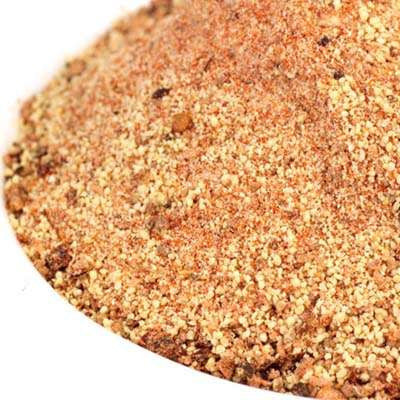 Applewood Chipotle Rub from The Olive Tap: A white bowl filled with grains of tan, brown, and orange spices.