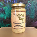Champagne Dill Mustard from The Olive Tap in a glass jar with a turquoise, black, and purple background.