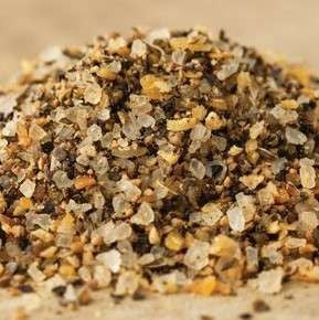 Montana Steak Seasoning from The Olive Tap: a pile of black, clear, and tan spices of different sizes on a light background.
