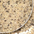 Garlic Pepper Seasoning from The Olive Tap: A metal bowl of tan ground spices with brown pieces and flakes.