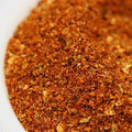 Salt-Free Mexican Fiesta Seasoning from The Olive Tap: A white bowl of brown, red, and tan spices of different sizes mixed together.