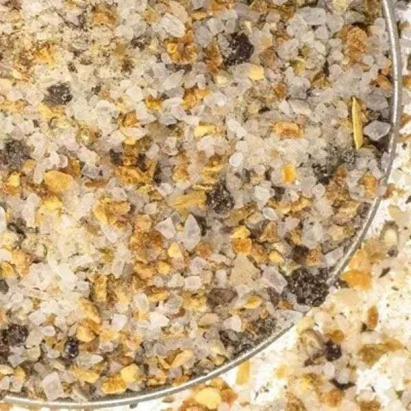 Smoky Citrus Sea Salt from The Olive Tap: White pebble-sized chunks of salt mixed with brown and tan pieces.